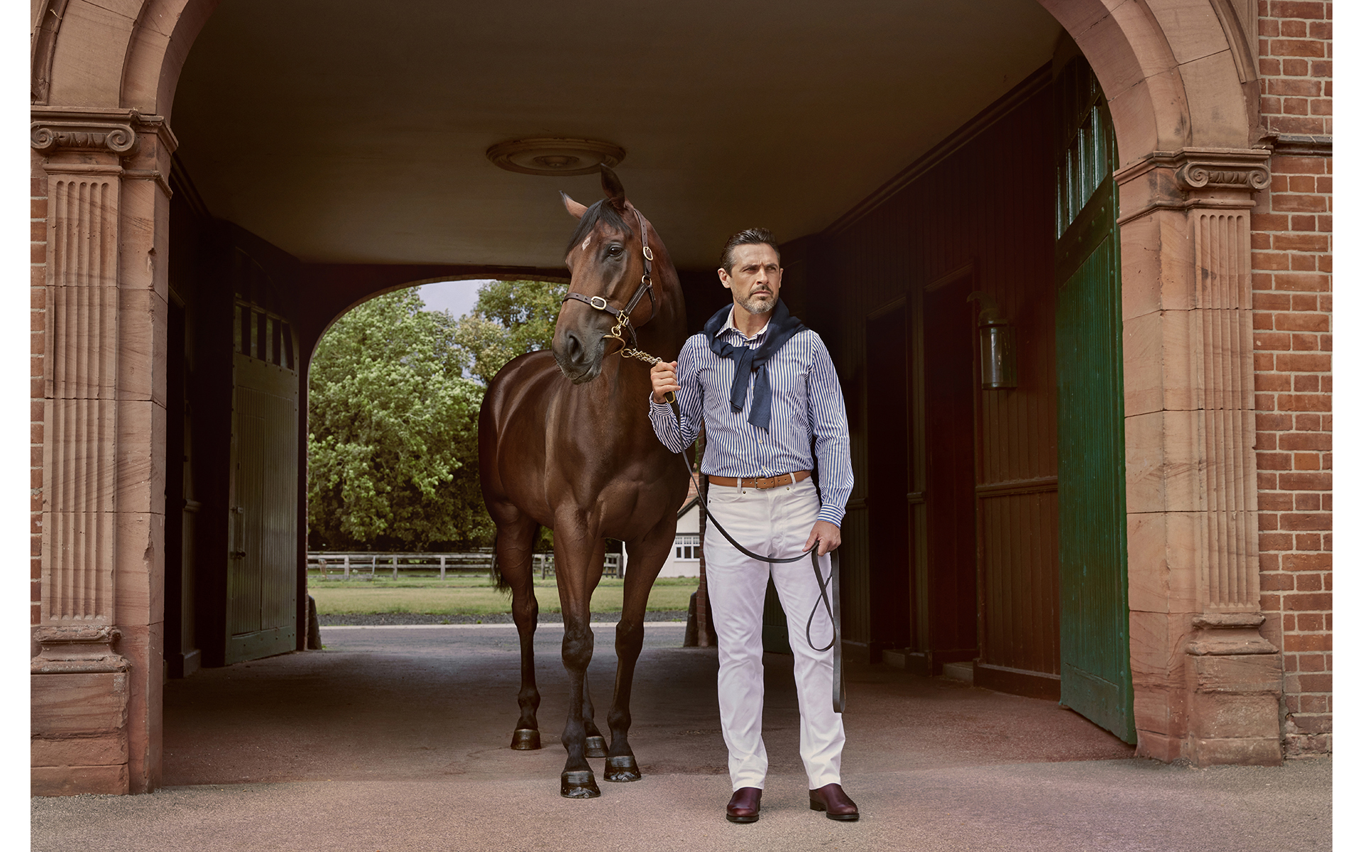 advertising fashion photo shoot for Paul brown clothing male model with horse at egerton house newmarket suffolk